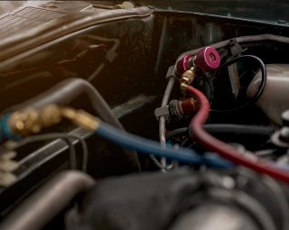 Air technicians are filling the car air conditioning liquid.