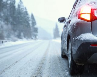 Car on country road in winter day