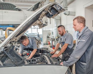 Car repair and cleaning concept - car engine close-up, wiping parts under the hood