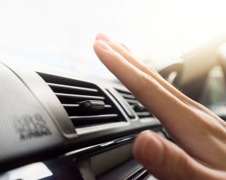 Closeup of hand checking the air conditioner in the car,