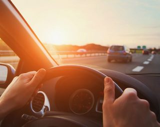 hands-of-car-driver-on-steering-wheel