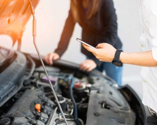 Man calling to car mechanic service after car engine breakdown