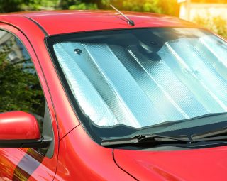 Sun shade under windshield in car