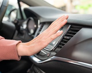 The air conditioning button inside a car.